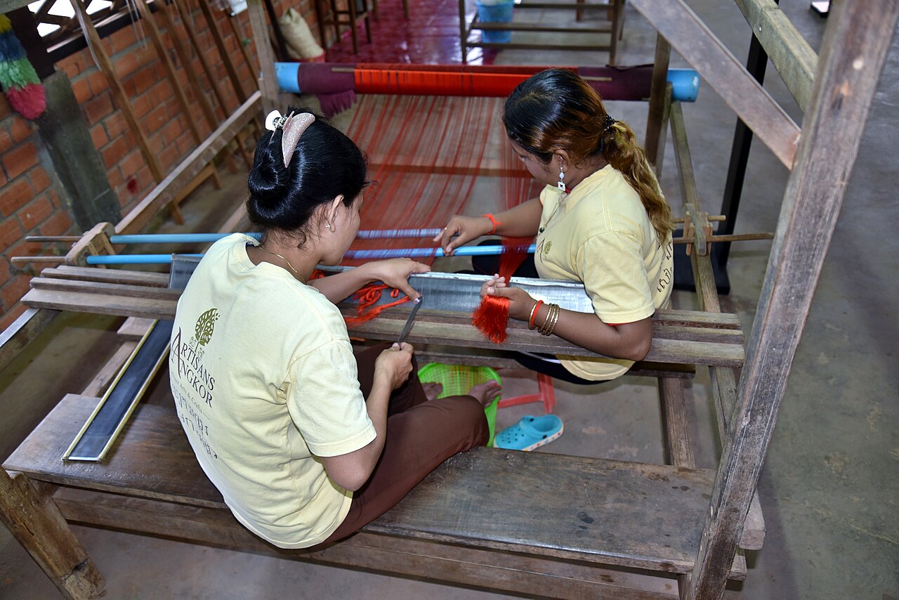 Silk workers preparing a handloom at the Artisans Angkor silk farm in 2018